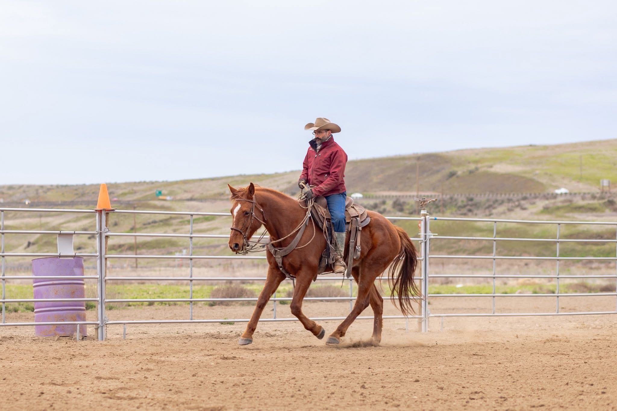 Eddie riding a chestnut horse in a training arena